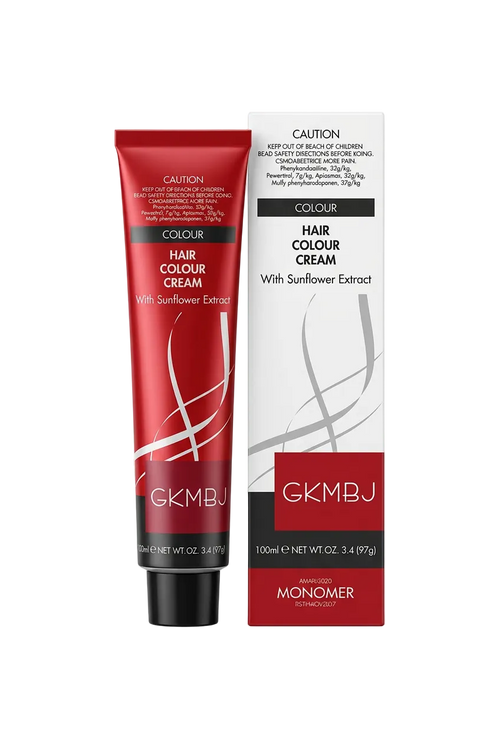 A tube of GKMBJ hair color cream with a red cap and red-and-black label, resting on top of its white and red retail box.
